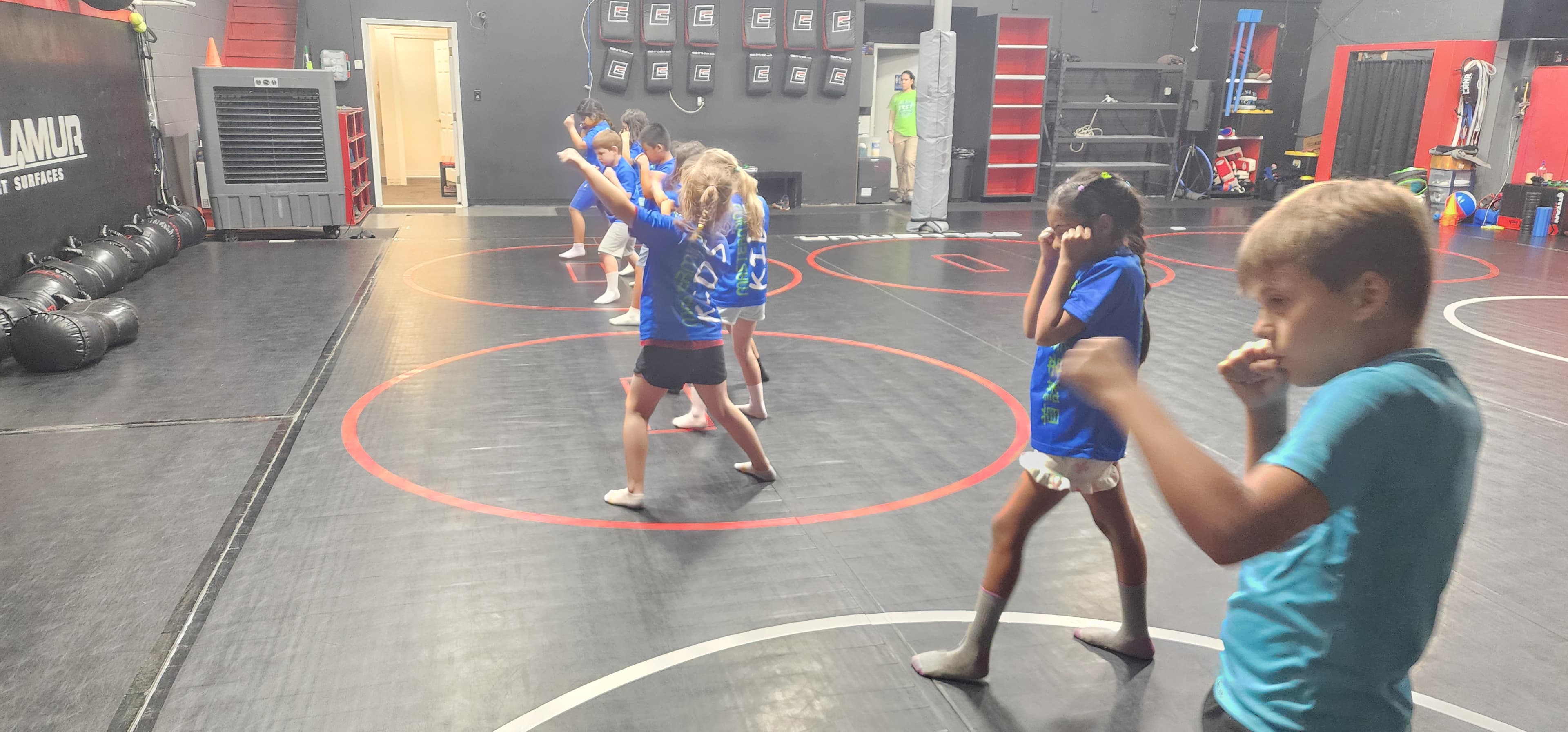 Campers practicing martial-arts techniques on the mats