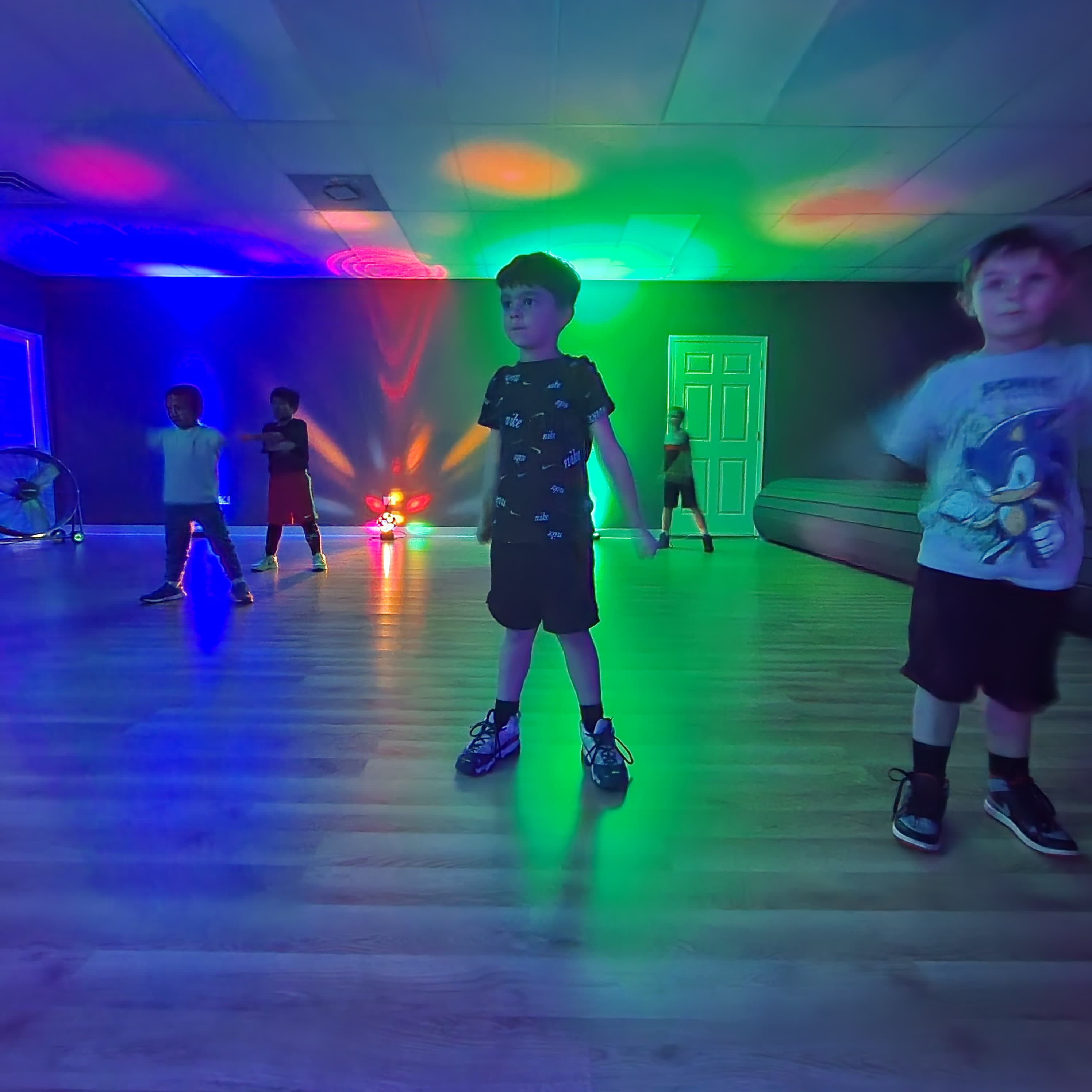 Campers dancing under colorful lights