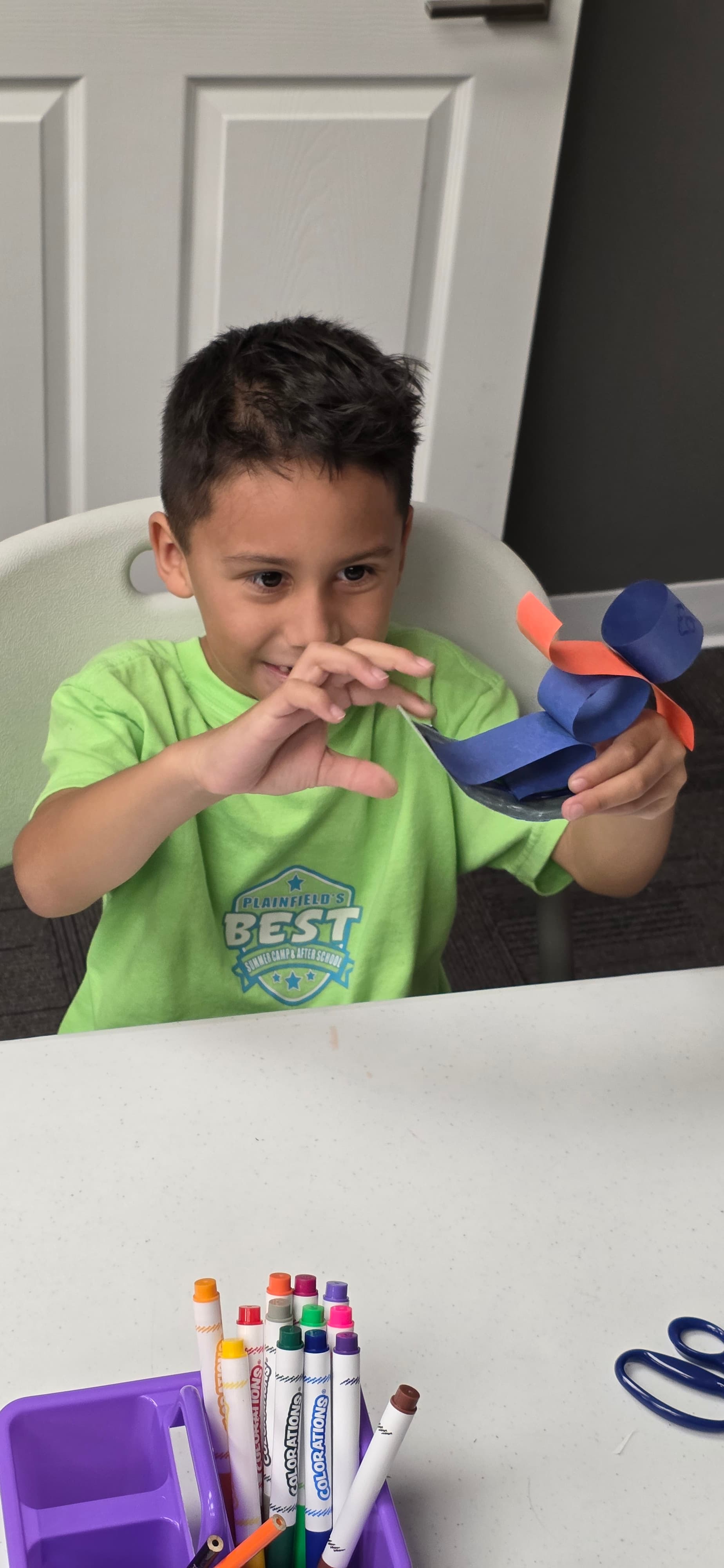 Camper making a craft during a school-break camp day